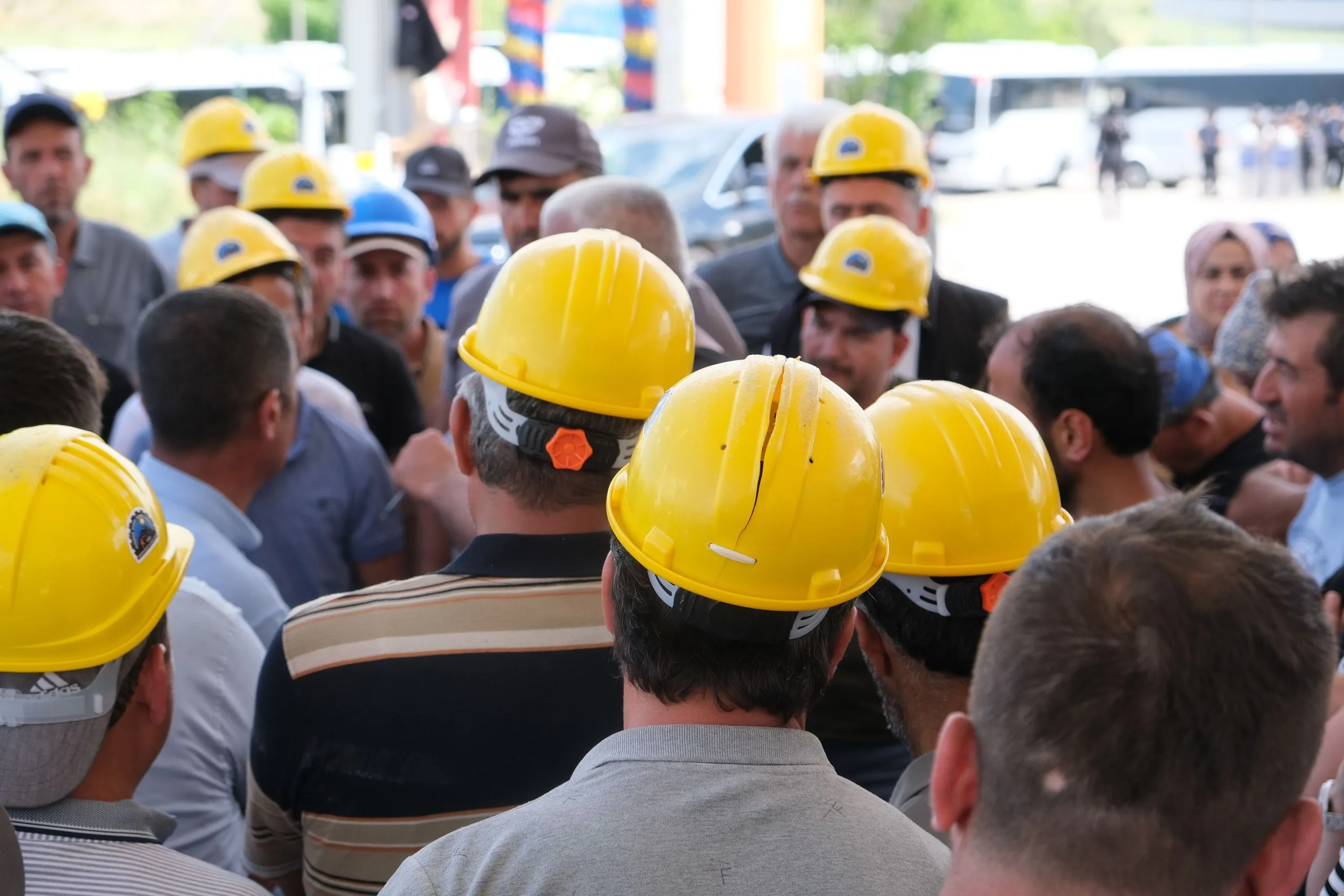 Workers in hard hats gathered for a safety briefing